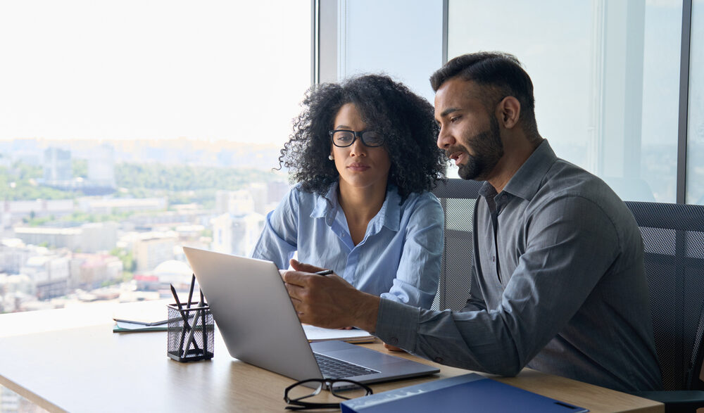 Two sales people working together on AI audio ads